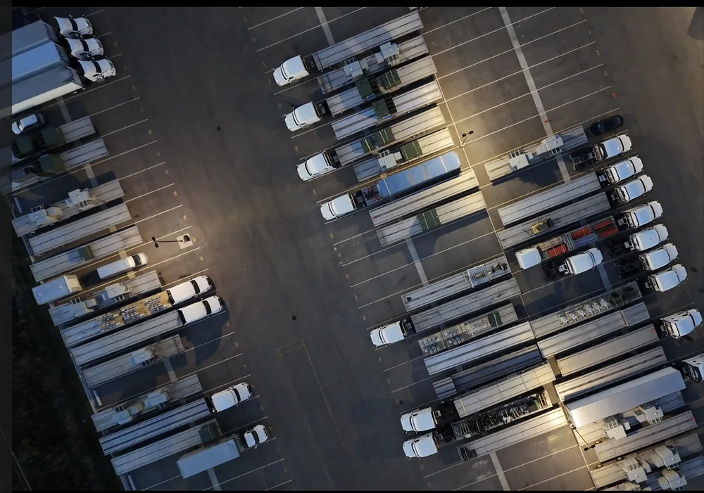 Rows of trucks and trailers parked on RT Group's paved lot in Zion, IL