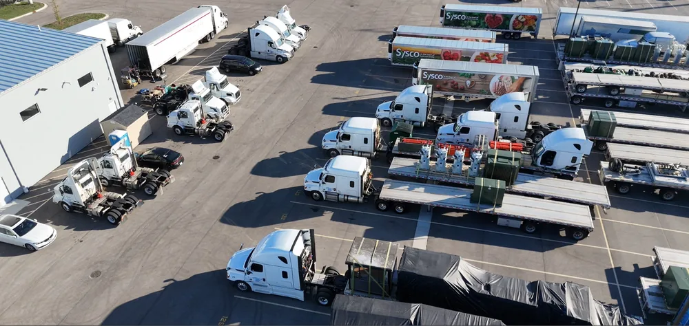Wide aerial view of RT Group's truck parking yard in Zion, IL near the pond